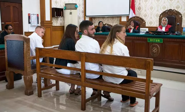 British nationals, Phineas Float, fourth right, Jonathan Collyer, second right and Lisa Stocker, right who are accused of smuggling nearly a kilogram (over two pounds) of cocaine into Indonesia sit on the defendant's chair before being sentenced for drug offenses at the district court in Denpasar, Bali, Indonesia on Thursday, July 24, 2025. (AP Photo/Firdia Lisnawati)