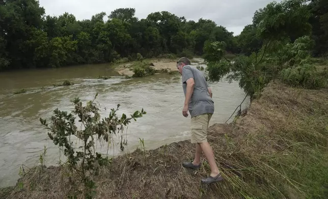 Jon Meredith, co-owner of Sweet Eats, looks over into the San Gabriel River following recent flooding Wednesday, July 9, 2025, near his farm in Georgetown, Texas. (AP Photo/Joshua A. Bickel)