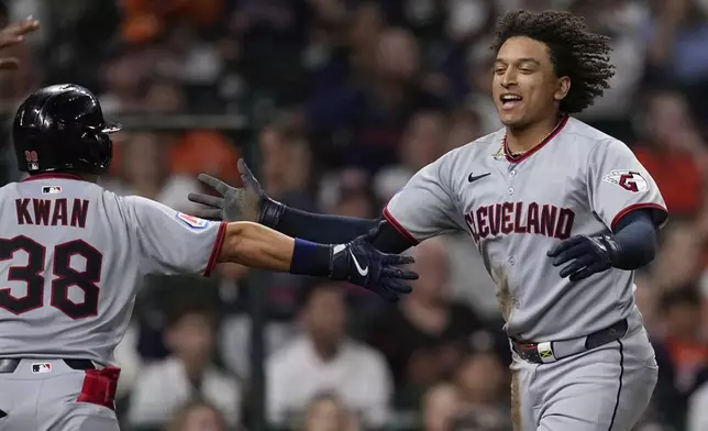 Cleveland Guardians' Bo Naylor, right, celebrates with Steven Kwan (38) after scoring against the Houston Astros during the sixth inning of a baseball game Monday, July 7, 2025, in Houston. (AP Photo/David J. Phillip)