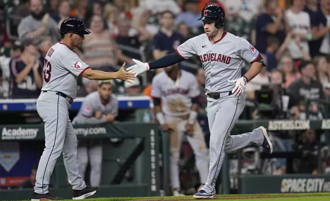 Cleveland Guardians' David Fry, right, celebrates with third base coach Rouglas Odor after hitting a home run against the Houston Astros during the ninth inning of a baseball game Monday, July 7, 2025, in Houston. (AP Photo/David J. Phillip)