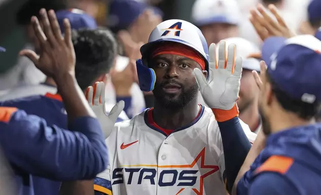 Houston Astros' Taylor Trammell celebrates in the dugout after hitting a three-run home against the Cleveland Guardians during the fifth inning of a baseball game Monday, July 7, 2025, in Houston. (AP Photo/David J. Phillip)