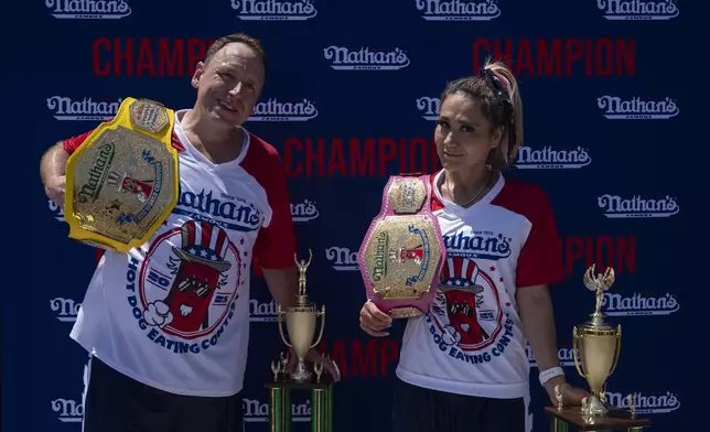 This year's woman's champion Miki Sudo, right, and man's champion Joey Chestnut, left, pose for a picture after the 2025 Nathan's Famous Fourth of July hot dog eating contest in the Coney Island section of the Brooklyn borough of New York, Thursday, July 4, 2025. (AP Photo/Yuki Iwamura)