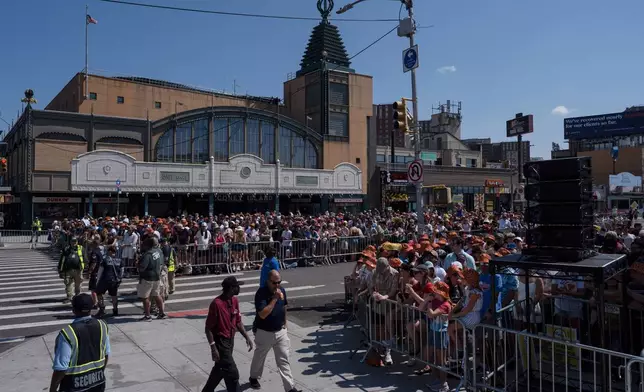 People gather ahead of the 2025 Nathan's Famous Fourth of July hot dog eating contest in the Coney Island section of the Brooklyn borough of New York, Thursday, July 4, 2025. (AP Photo/Yuki Iwamura)