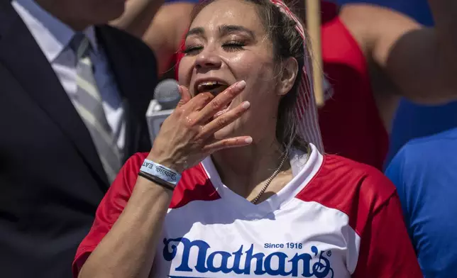 Competitive eater Miki Sudo eats hot dog during the 2025 Nathan's Famous Fourth of July hot dog eating contest in the Coney Island section of the Brooklyn borough of New York, Thursday, July 4, 2025. (AP Photo/Yuki Iwamura)