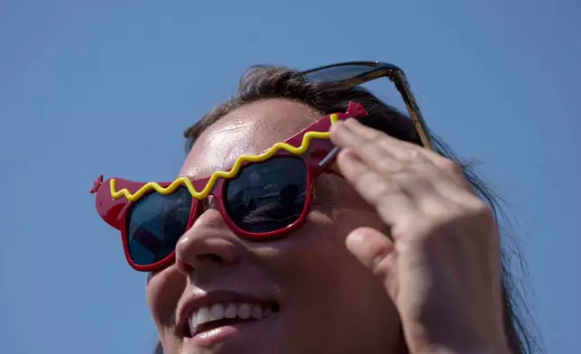 A person is seen wearing a hot dog shaped sunglasses ahead of the 2025 Nathan's Famous Fourth of July hot dog eating contest in the Coney Island section of the Brooklyn borough of New York, Thursday, July 4, 2025. (AP Photo/Yuki Iwamura)