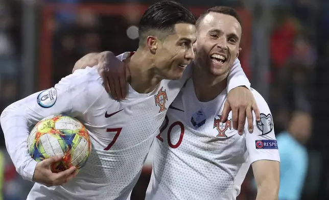 FILE - Portugal's Cristiano Ronaldo, left, celebrates with his teammate Diogo Jota after he scored his side's second goal during the Euro 2020 group B qualifying soccer match between Luxembourg and Portugal at the Josy Barthel stadium in Luxembourg, Sunday, Nov. 17, 2019. (AP Photo/Francisco Seco, File)