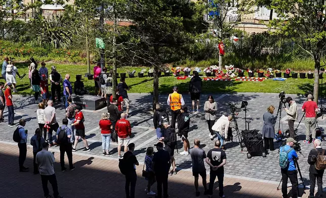 People gather to leave tributes at Anfield Stadium, home of Liverpool, in memory of Liverpool player Diogo Jota, Thursday July 3, 2025. (Peter Byrne/PA via AP)