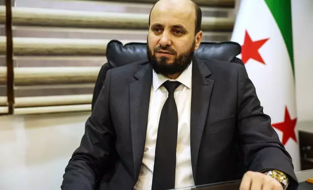 Syrian Minister of Energy, Mohammad Al-Bashir, speaks during an interview with the Associated Press in Damascus, Syria, Monday, June 30, 2025. (AP Photo/Ghaith Alsayed)