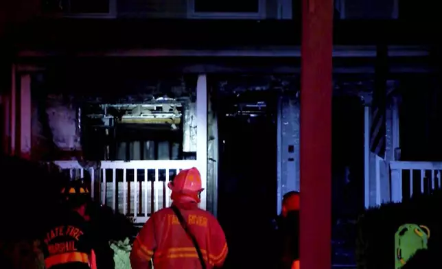 This image taken from video provided by WLNE-TV shows a firefighter working on the aftermath of a fire at an assisted living facility in Fall River, Mass., Sunday, July 13, 2025. (WLNE-TV via AP)