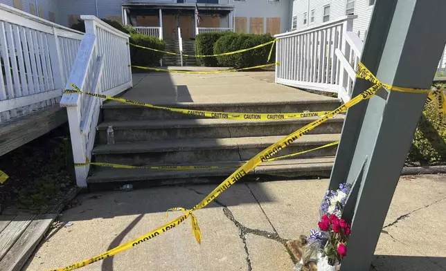 Flowers sit in front of the Gabriel House assisted living facility where a fire on Sunday killed several people, Tuesday, July 15, 2025 in Fall River, Mass. (AP Photo/Kimberlee Kruesi)