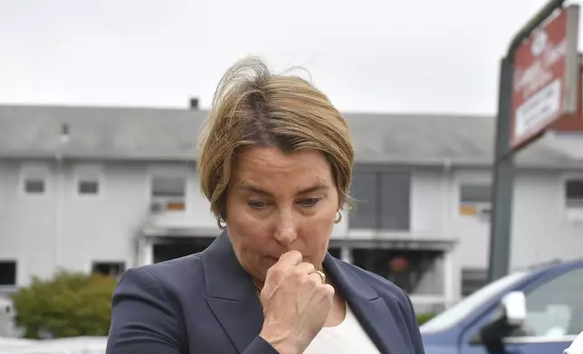 Massachusetts Gov. Maura Healey approaches a news conference to face reporters Monday, July 14, 2025, near the Gabriel House assisted living facility, behind, following a fire that started late Sunday in Fall River, Mass. (AP Photo/Steven Senne)