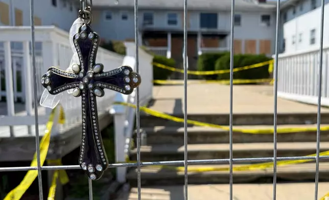 Flowers sit at a makeshift memorial in front of the Gabriel House assisted living facility, where a fire on Sunday killed several people, Wednesday, July 16, 2025 in Fall River, Mass. (AP Photo/Rodrique Ngowi)