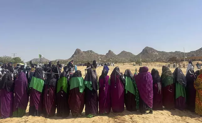 Female performers from El Mihan, Algeria stand together during the Sebeiba festival dance competition in Djanet, a southeastern Algerian oasis town in the Sahara desert, on July 6, 2025. (AP Photo/Audrey Thibert)