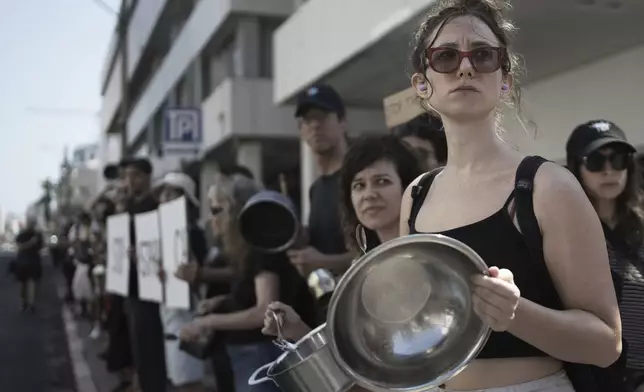 Israeli activists bang pots and pans to protest the starvation of Palestinian civilians in the Gaza Strip, outside of the U.S. Embassy branch office in Tel Aviv, Israel, Thursday, July 24, 2025. (AP Photo/Maya Alleruzzo)