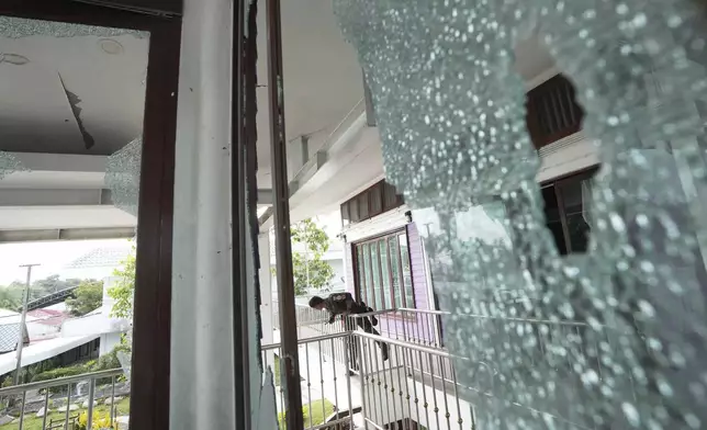 A Thai soldier stands at the Phanom Dong Rak hospital damaged after Cambodia fired artillery shells in Surin Province, Thailand, Friday, July 25, 2025. (AP Photo/Sakchai Lalit)