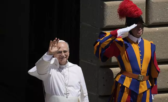 Pope Leo XIV waves to faithful at the end of the noon Angelus prayer in the square in front of the Apostolic Palace for in Castel Gandolfo, Italy, Sunday, July 20, 2025. (AP Photo/Gregorio Borgia)