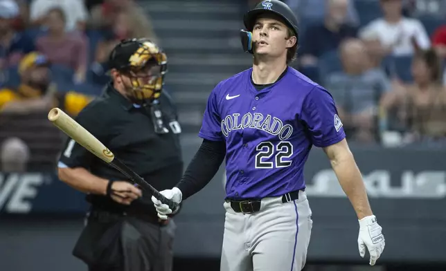 Colorado Rockies' Mickey Moniak reacts after a strike out by Cleveland Guardians starting pitcher Hunter Gaddis during the eighth inning of a baseball game, Wednesday, July 30, 2025, in Cleveland. (AP Photo/Phil Long)