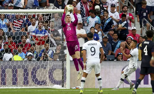 United States goalkeeper Matthew Freese (25) makes a save while Guatemala forward Rubio Mendez (9) and Oscar Santis (18) watch during the second half of a CONCACAF Gold Cup semifinal soccer match, Wednesday, July 2, 2025, in St. Louis. (AP Photo/Scott Kane)