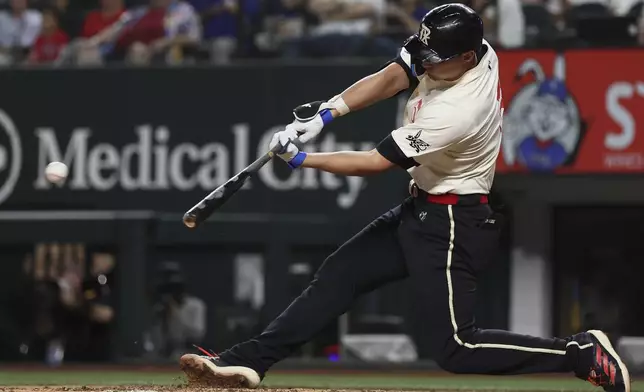 Texas Rangers' Corey Seager hits a two RBI double during the eighth inning of a baseball game against the Detroit Tigers on Friday, July 18, 2025, in Arlington, Texas. (AP Photo/Sam Hodde)