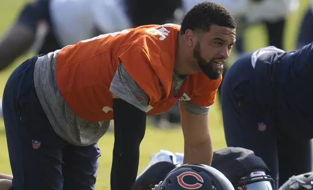 Chicago Bears quarterback Caleb Williams (18) stretches during practice at NFL football training camp, Wednesday, July 23, 2025, in Lake Forest, Ill. (AP Photo/Erin Hooley)
