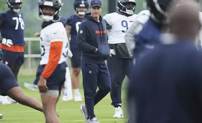 FILE - Chicago Bears head coach Ben Johnson watches players during NFL football practice at Halas Hall in Lake Forest, Ill., June 4, 2025. (AP Photo/Nam Y. Huh, File)
