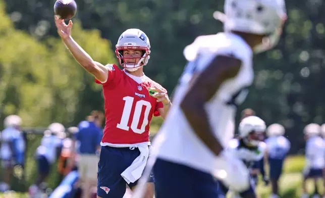 New England Patriots quarterback Drake Maye throws a pass during practice at the team's NFL football training camp, Wednesday, July 23, 2025, in Foxborough, Mass. (AP Photo/Charles Krupa)