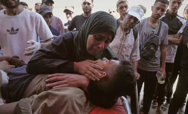 Nabila Al Shaer, center, mourns the body of her son, Jamil Al Shaer, 21, who was killed while trying to receive aid from the U.S.-backed Gaza Humanitarian Foundation (GHF) in Netzarim, in the central Gaza Strip, at Al-Aqsa Hospital, Thursday, July 31, 2025.(AP Photo/Abdel Kareem Hana)