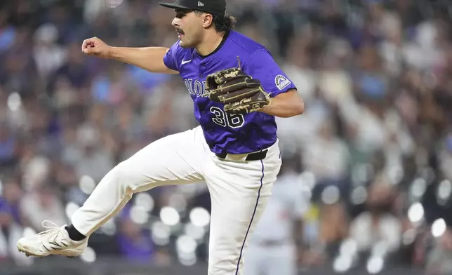 Colorado Rockies relief pitcher Zach Agnos works against the Minnesota Twins in the ninth inning of a baseball game Saturday, July 19, 2025, in Denver. (AP Photo/David Zalubowski)