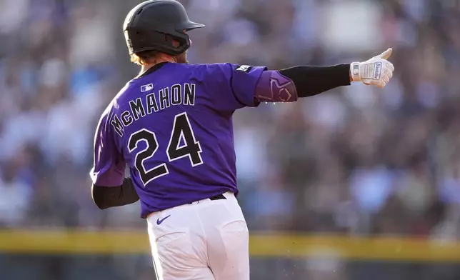 Colorado Rockies' Ryan McMahon gestures to the bullpen as he circles the bases after hitting a two-run home run off Minnesota Twins starting pitcher Zebby Mtthews in the third inning of a baseball game Saturday, July 19, 2025, in Denver. (AP Photo/David Zalubowski)