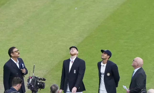 England's captain Ben Stokes, second left, and India's captain Shubman Gill, second right, look at coin during toss on the first day of the fourth cricket test match between England and India at Emirates Old Trafford, Manchester, England, July 23, 2025.(AP Photo/Jon Super)
