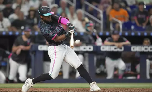 Miami Marlins' Otto Lopez hits a double to bring in two runs in the eighth inning of a baseball game against the Kansas City Royals, Saturday, July 19, 2025, in Miami. (AP Photo/Rebecca Blackwell)