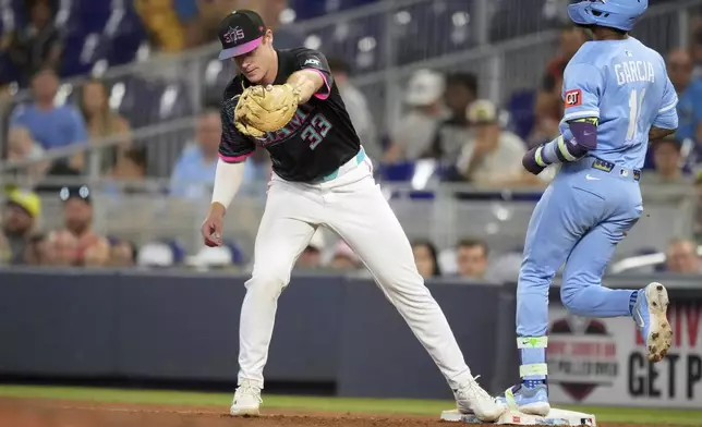 Miami Marlins first base Eric Wagaman catches the ball to get out Kansas City Royals Maikel Garcia and seal the win for the Marlins, in the ninth inning of a baseball game, Saturday, July 19, 2025, in Miami. (AP Photo/Rebecca Blackwell)