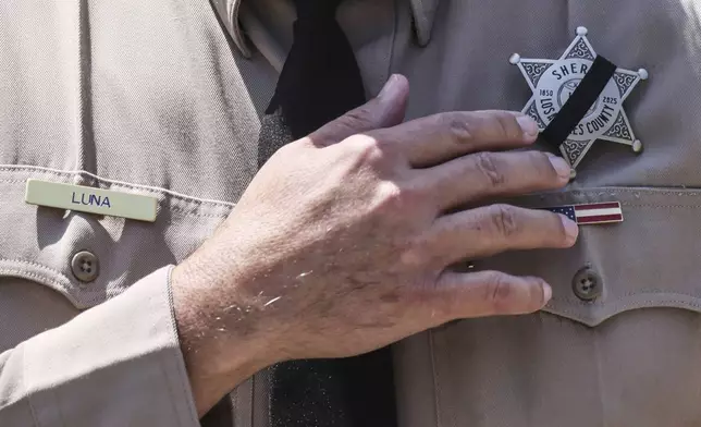 Los Angeles County Sheriff Robert Luna wears a band over his badge after three members of the department were killed in an explosion at a training facility on Friday, July 18, 2025, in Los Angeles. (AP Photo/Etienne Laurent)