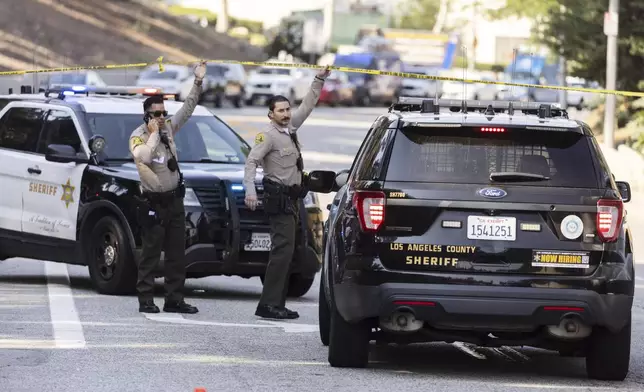 Sheriffs deputies monitor a street closure near the site of an explosion at the LA County Sheriff's Special Operations Bureau on Friday, July 18, 2025, in Los Angeles. (AP Photo/Etienne Laurent)