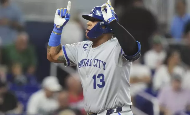 Kansas City Royals' Salvador Perez (13) gestures as he scores after hitting a solo home run during the eighth inning of a baseball game against the Miami Marlins, Sunday, July 20, 2025, in Miami. (AP Photo/Lynne Sladky)