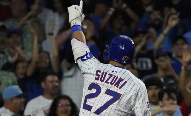 Chicago Cubs' Seiya Suzuki gestures after hitting a home run against the St. Louis Cardinals during the fifth inning of a baseball game Sunday, July 6, 2025, in Chicago. (AP Photo/David Banks)