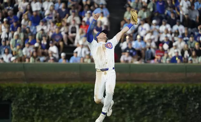 Chicago Cubs second baseman Nico Hoerner makes a catch on a ball hit by St. Louis Cardinals' Garrett Hampson during the fifth inning of a baseball game Sunday, July 6, 2025, in Chicago. (AP Photo/David Banks)