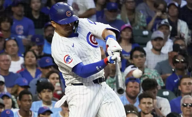 Chicago Cubs' Seiya Suzuki hits a one-run double against the St. Louis Cardinals during the third inning of a baseball game Sunday, July 6, 2025, in Chicago. (AP Photo/David Banks)