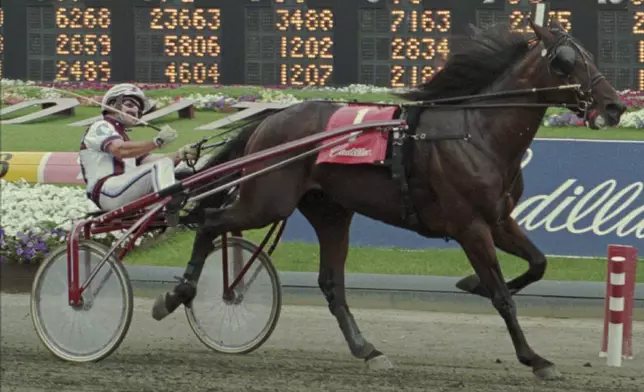 FILE - Tagliabue, with driver John Campbell, wins the $1 million Cadillac Hambletonian at the Meadowlands Racetrack in East Rutherford, N.J., Saturday, Aug. 5, 1995. (AP Photo/Bill Kostroun, File)