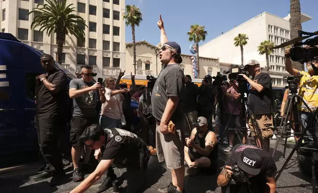 Visitors pay their respect at the star for Ozzy Osbourne at the Hollywood Walk of Fame on Tuesday, July 22, 2025, in Los Angeles. (AP Photo/Damian Dovarganes)
