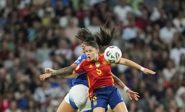 Spain's Maria Mendez jumps for the ball with Italy's Martina Piemonte, background, during the Women's Euro 2025, group B, soccer match between Italy and Spain at Stadion Wankdorf in Bern, Switzerland, Friday, July 11, 2025. (AP Photo/Martin Meissner)