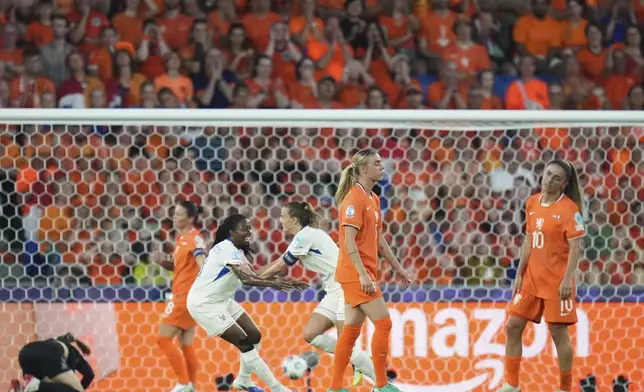 Netherlands' Jill Roord, center, and Danielle van de Donk, right, react after France's Sandie Toletti, background center, score the opening goal during the Women's Euro 2025, group D, soccer match between the Netherlands and France at St. Jakob-Park in Basel, Switzerland, Sunday, July 13, 2025. (AP Photo/Alessandra Tarantino)