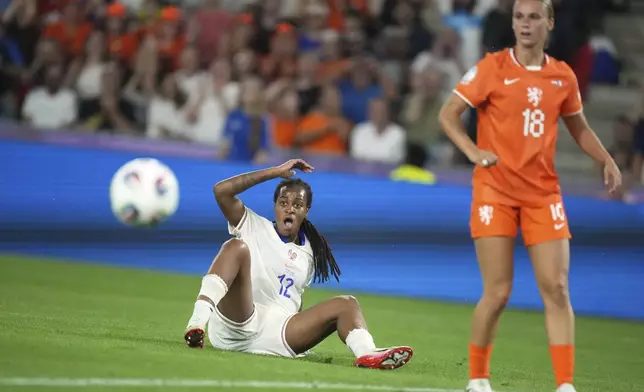 France's Marie-Antoinette Katoto, left, and Netherlands' Kerstin Casparij watch France's Delphine Cascarino score her side's fourth goal during the Women's Euro 2025, group D, soccer match between the Netherlands and France at St. Jakob-Park in Basel, Switzerland, Sunday, July 13, 2025. (AP Photo/Alessandra Tarantino)