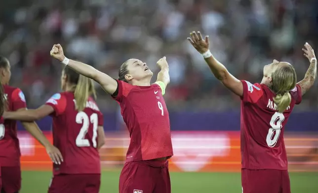 Poland's Ewa Pajor, centre, celebrates with Poland's Ewelina Kamczyk after scoring her side's second goal during the Women's Euro 2025, group C, soccer match between Poland and Denmark at Allmend Stadion Luzern in Lucerne, Switzerland, Saturday, July 12, 2025. (AP Photo/Alessandra Tarantino)