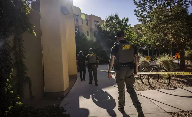 Authorities investigate a deadly shooting at Casas del Rio (Gila), a student housing center at the University of New Mexico Central Campus. early Friday, July 25, 2025 in Albuquerque, N.M. (Chancey Bush/The Albuquerque Journal via AP)