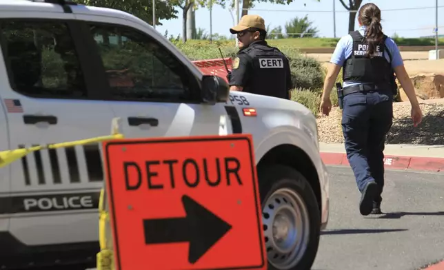 Authorities block access to an area on the University of New Mexico campus where two people were shot, one of them fatally, in the early morning hours in Albuquerque, N.M., on Friday, July 25, 2025. (AP Photo/Susan Montoya Bryan)