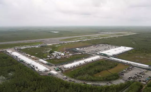 Work progresses on a new migrant detention facility dubbed "Alligator Alcatraz," at Dade-Collier Training and Transition facility in the Florida Everglades, Friday, July 4, 2025, in Ochopee, Fla. (AP Photo/Rebecca Blackwell)
