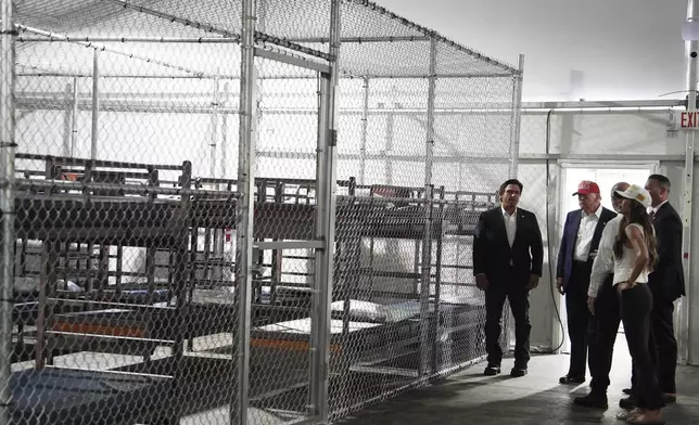 President Donald Trump, Gov. Ron DeSantis, R-Fla., and Homeland Security Secretary Kristi Noem, and others, tour "Alligator Alcatraz," a new migrant detention facility at Dade-Collier Training and Transition facility, Tuesday, July 1, 2025, in Ochopee, Fla. (AP Photo/Evan Vucci)