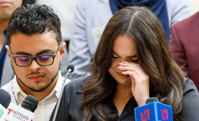 Spanish-language journalist Mario Guevara's daughter Katherine Guevara reacts as she struggles to find words during a press conference at the Georgia State Capitol in Atlanta, on Tuesday, July 22, 2025. (Miguel Martinez/Atlanta Journal-Constitution via AP)