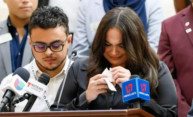 Spanish-language journalist Mario Guevara's daughter, Katherine Guevara, reacts as she struggles to find words during a press conference at the Georgia State Capitol in Atlanta, on Tuesday, July 22, 2025. (Miguel Martinez/Atlanta Journal-Constitution via AP)